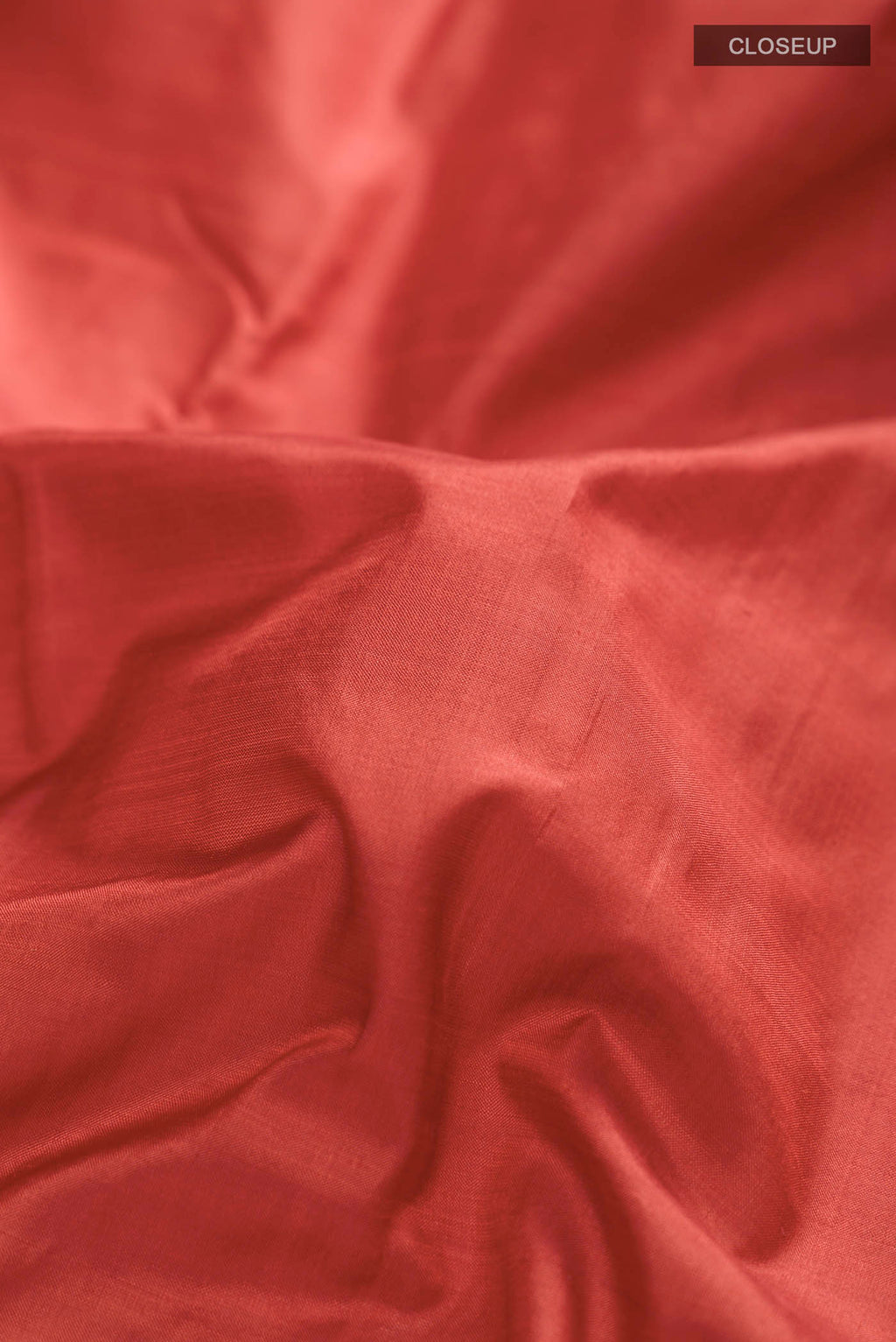 Close up of Rust Kanchipuram Silk Nine Yards Saree with Plain Body and Zari Border displaying folds