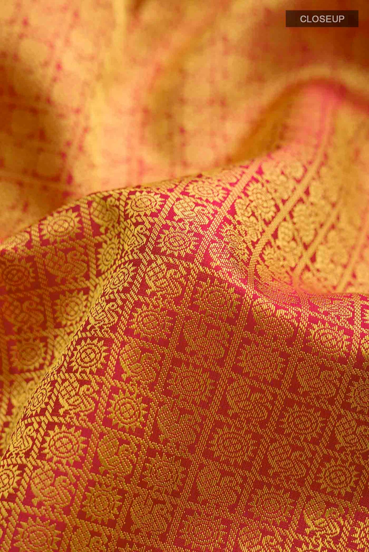 Close up of Maroon Kanchipuram Silk Saree with Jacquard design on the body and Zari Border displaying folds