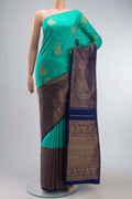 Green Kanchipuram Silk Saree with Zari Butta on the body and Zari Border displayed on a mannequin
