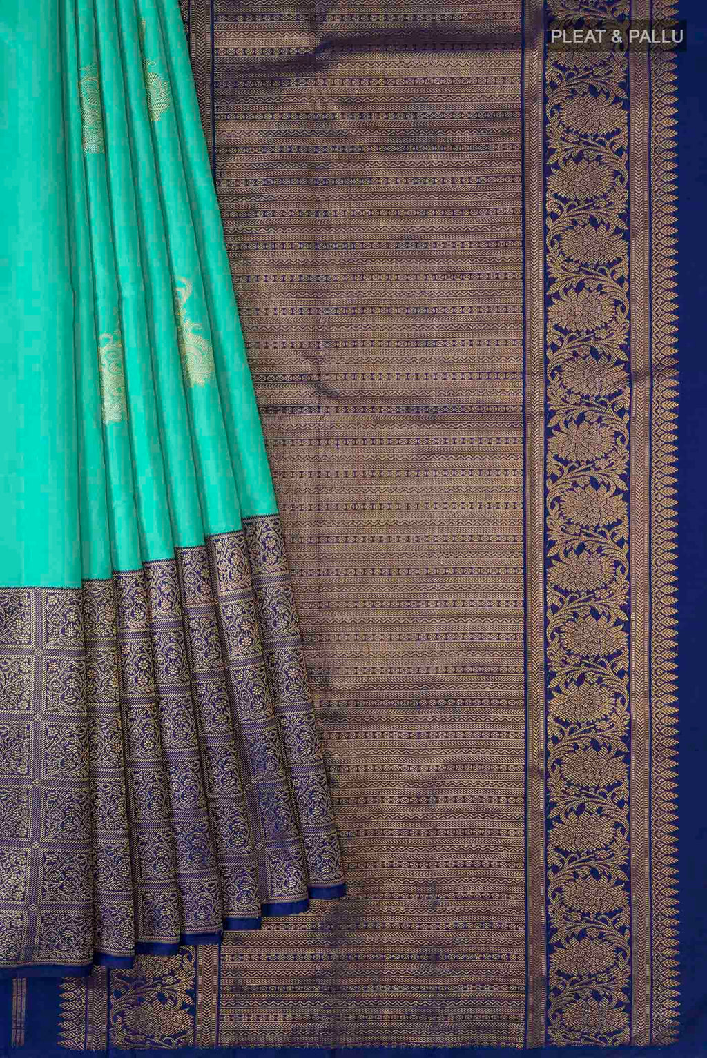 Pleats and pallu of Green Kanchipuram Silk Saree with Zari Butta on the body and Zari Border