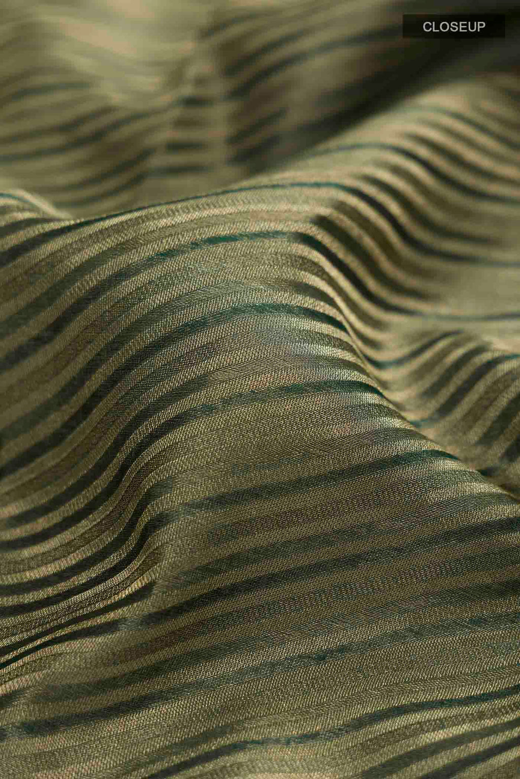 Close up of Bottle Green Mysore Georgette Saree with Stripes on the body and Zari Border displaying folds