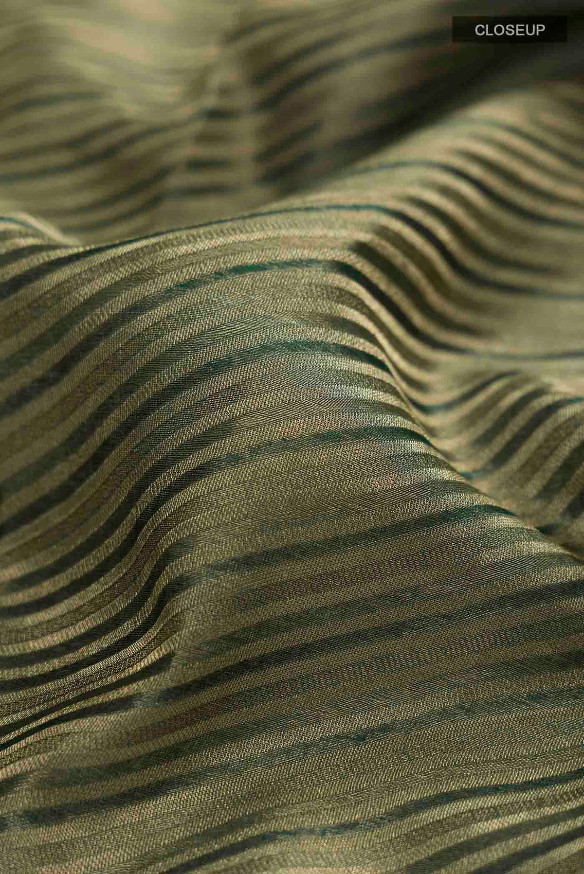 Close up of Bottle Green Mysore Georgette Saree with Stripes on the body and Zari Border displaying folds