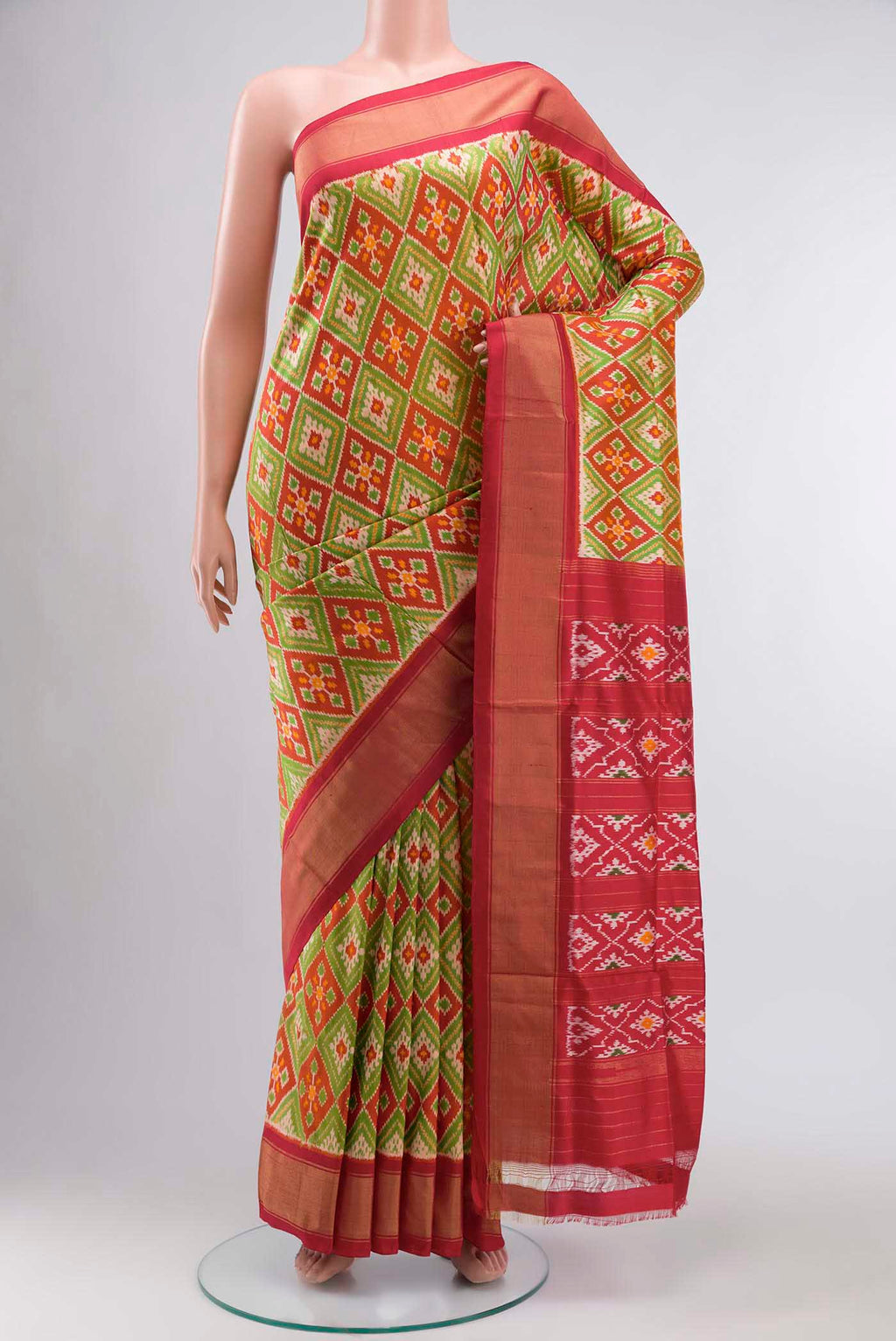 Rust Pochampally Silk Saree with Pure Ikat on the body and Zari Border displayed on a mannequin