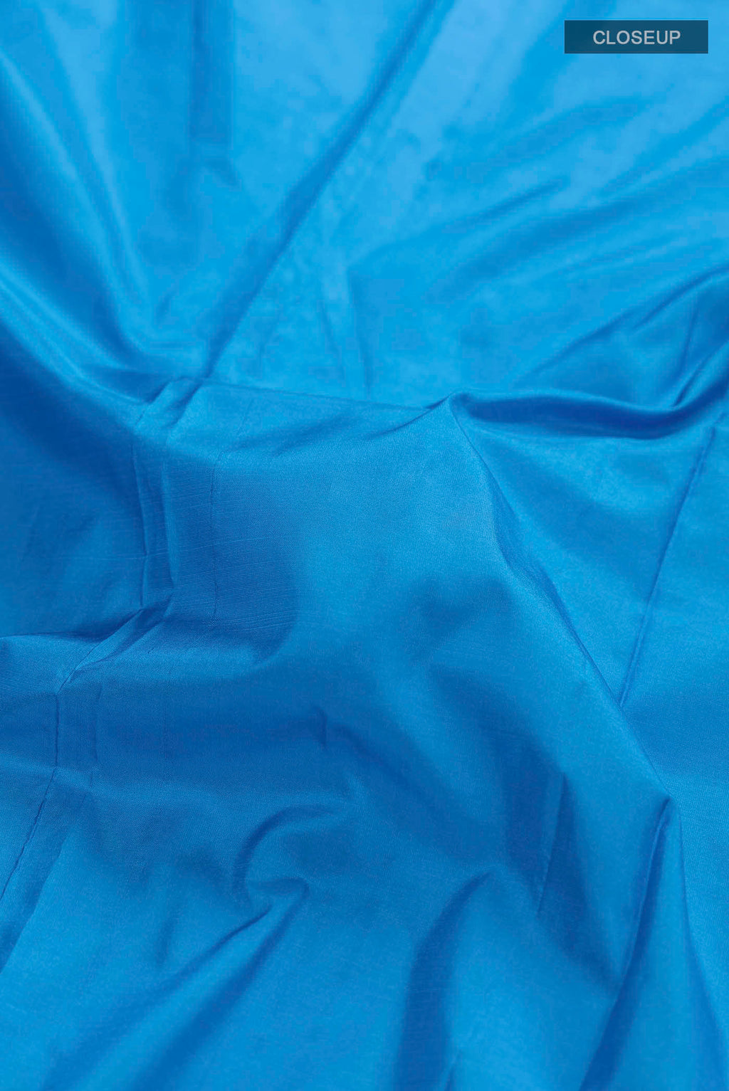 Close up of Blue Bangalore Silk Saree with Plain Body and Zari Border displaying folds