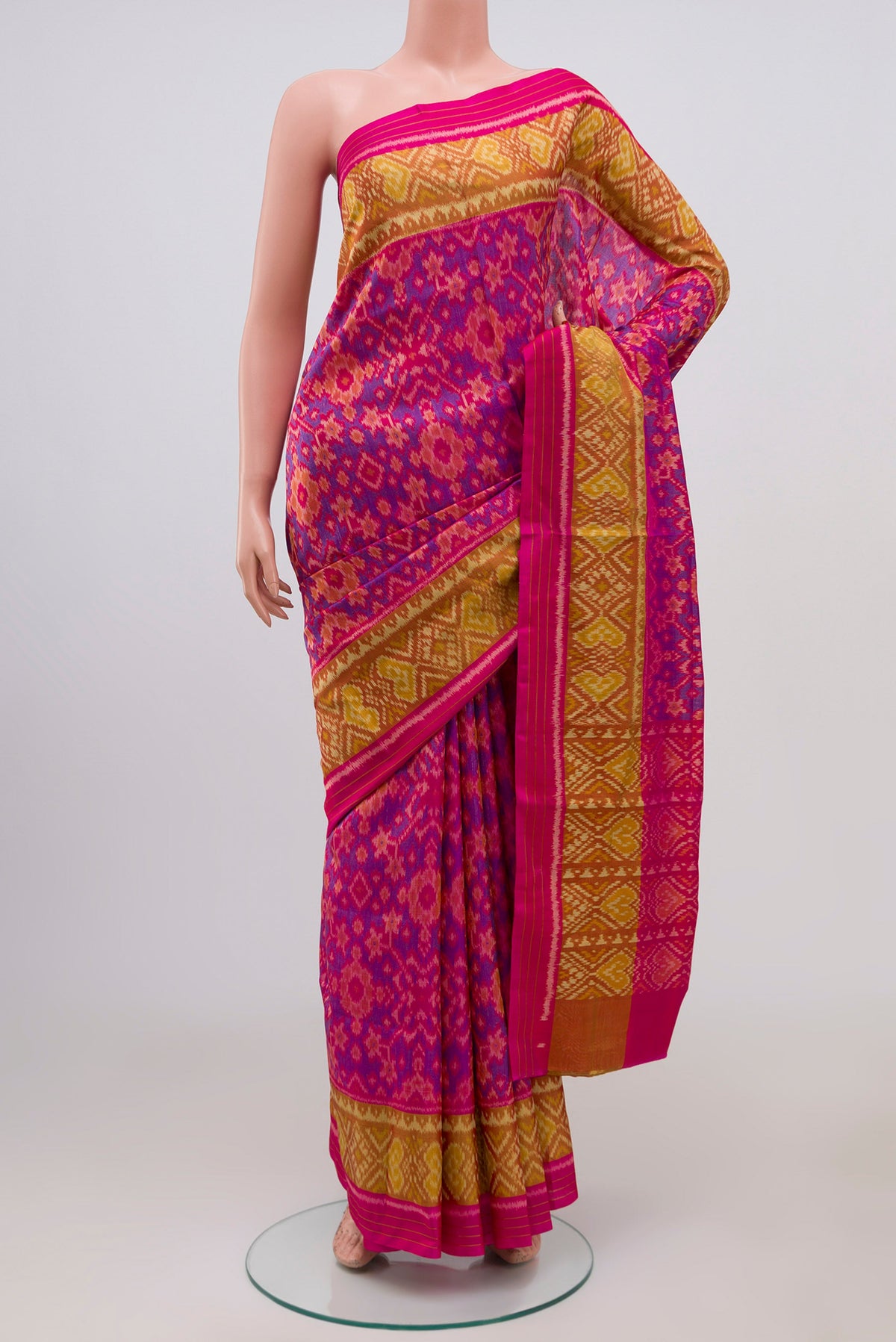 Pink Rajkot Patola Silk Saree with Ikat Print on the body and Ikat Border.  displayed on a mannequin