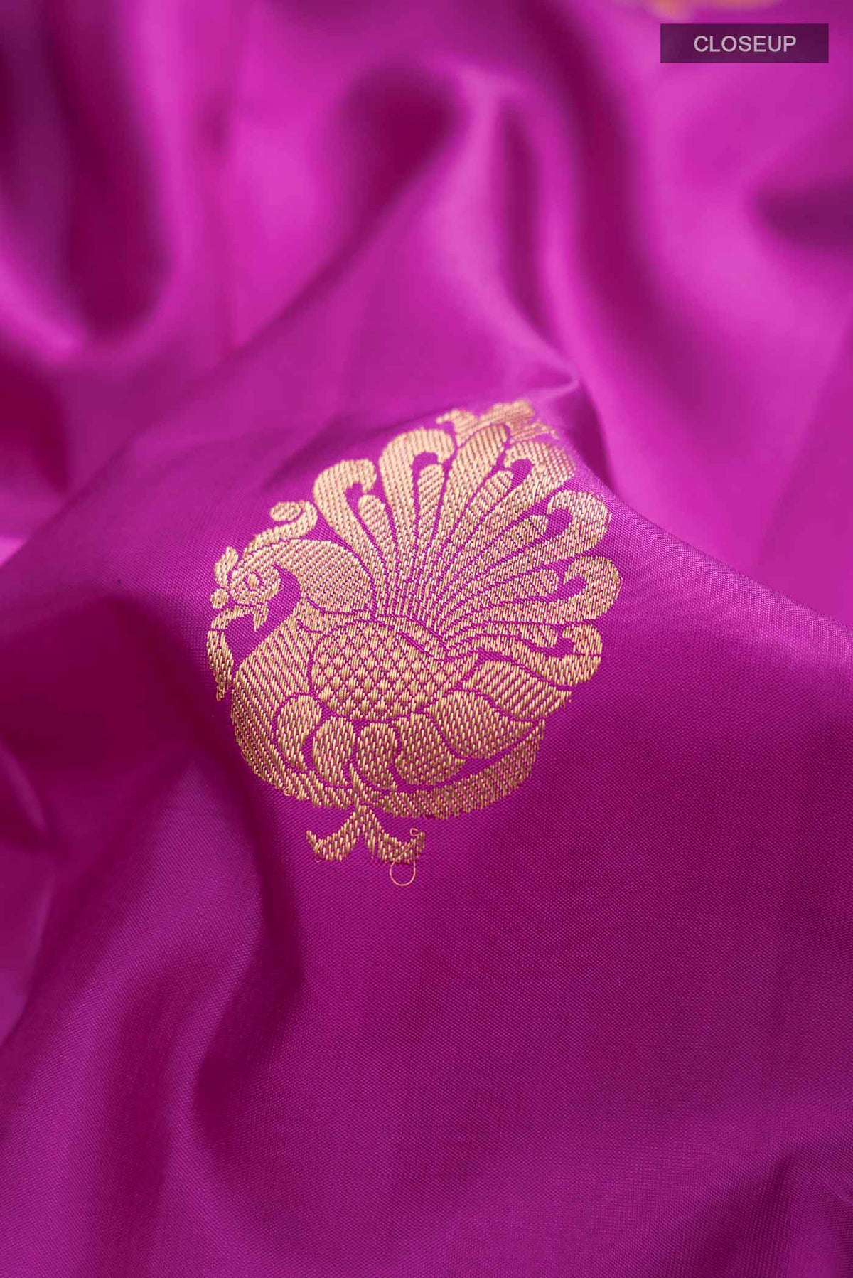 Close up of Purple Kanchipuram Silk Saree with Zari Butta on the body and Zari Border displaying folds