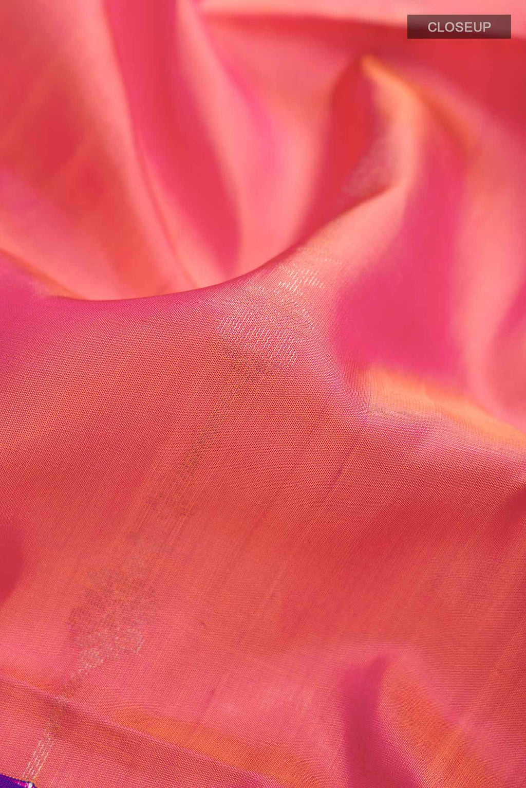 Close up of Pink Soft Silk Saree with Zari Butta on the body and Zari Border displaying folds