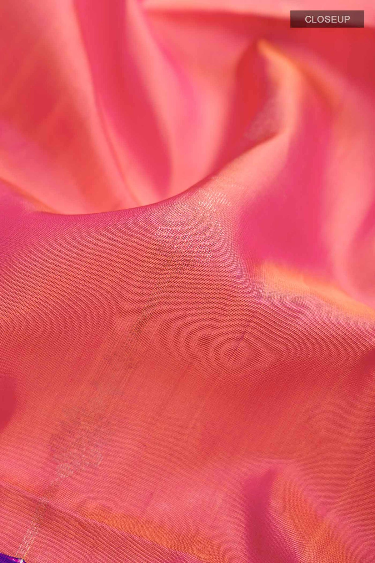 Close up of Pink Soft Silk Saree with Zari Butta on the body and Zari Border displaying folds