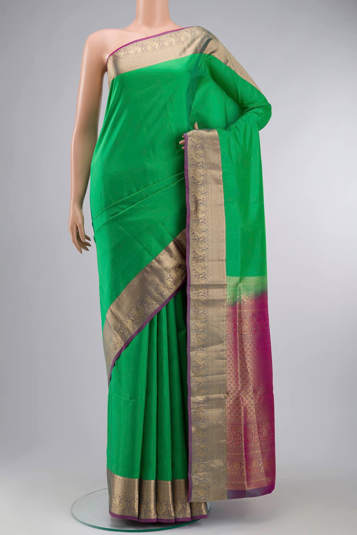 Green Soft Silk Saree with Plain Body and Zari Border displayed on a mannequin