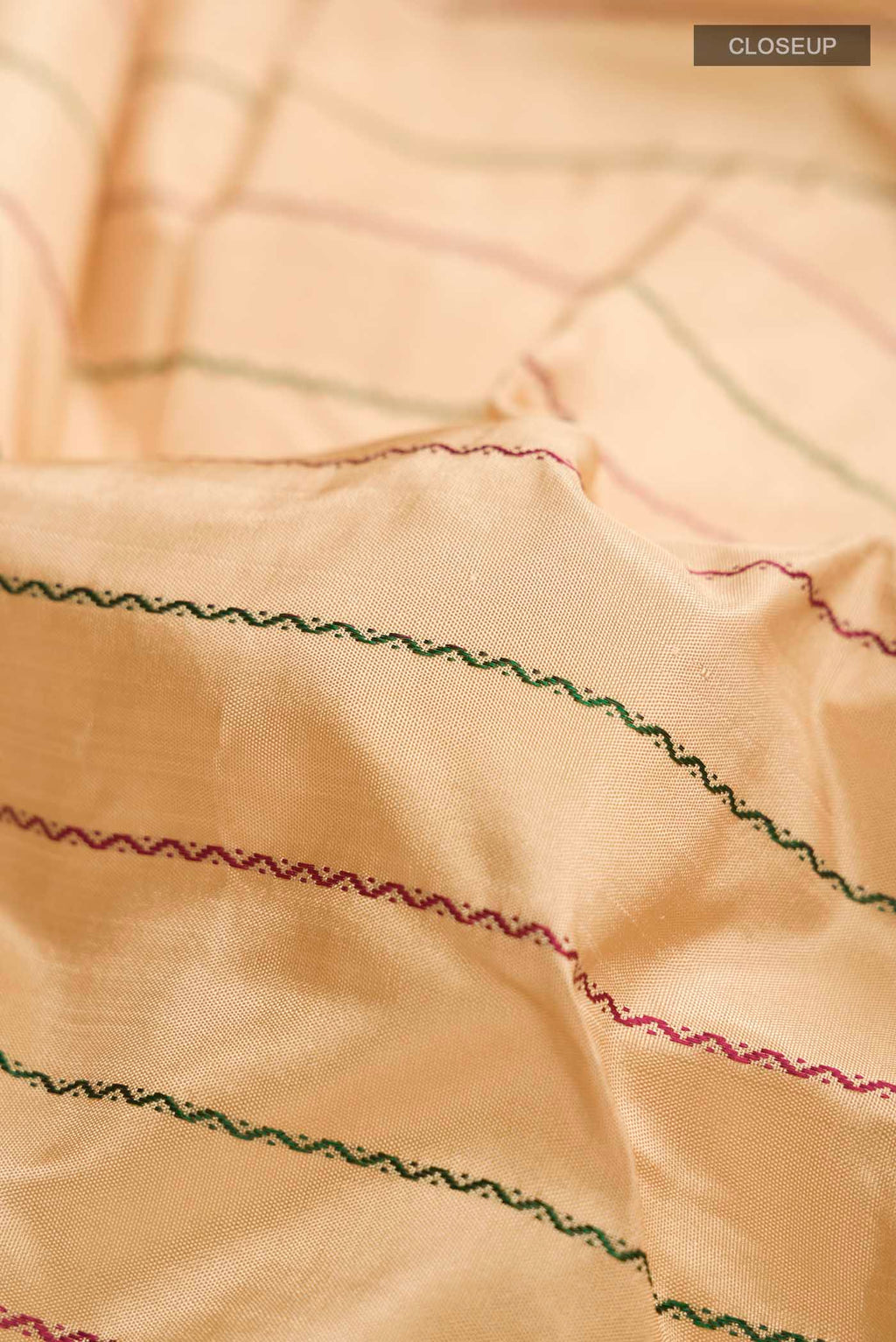 Close up of Sandal Kanchipuram Silk Saree with Veldhari on the body and Zari Border displaying folds