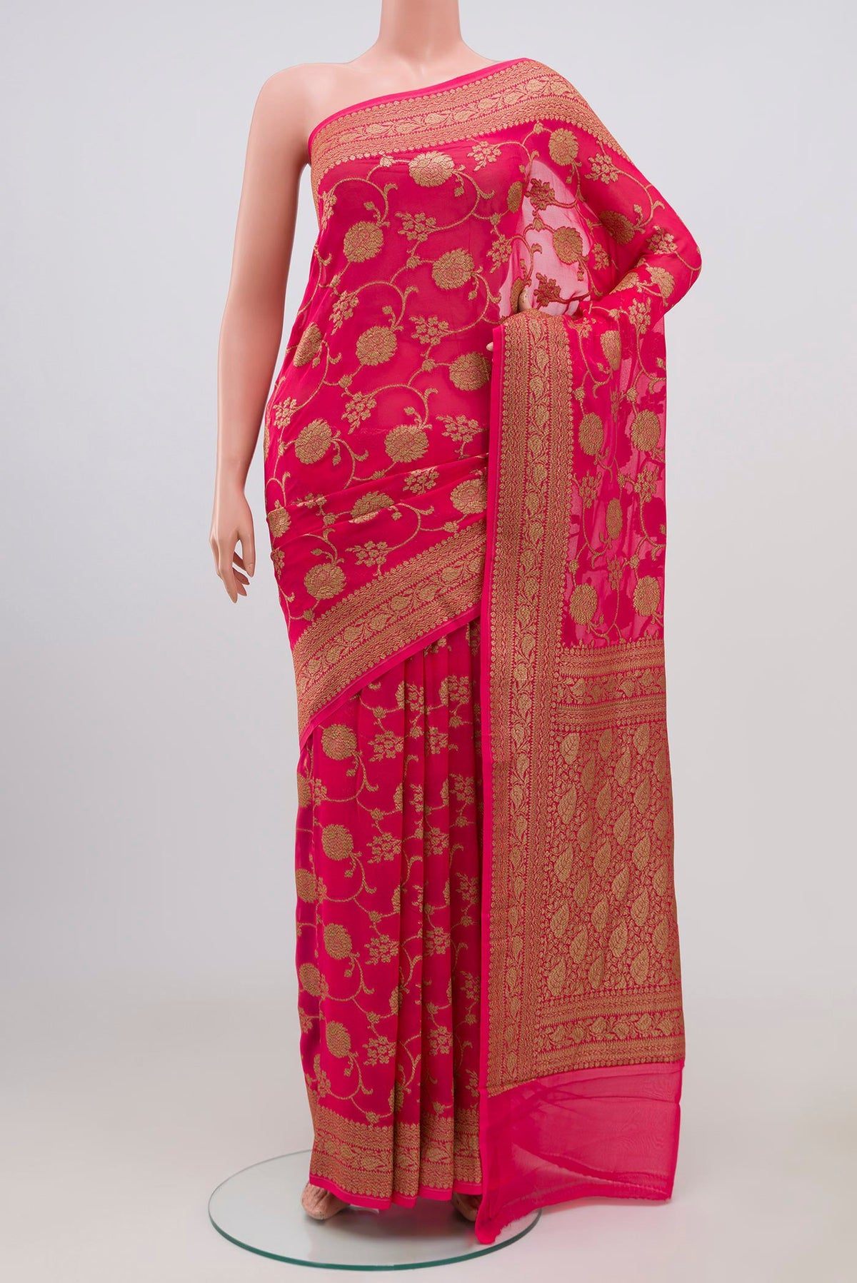 Pink Banarasi Georgette Saree with Fancy on the body and Zari Border.  displayed on a mannequin