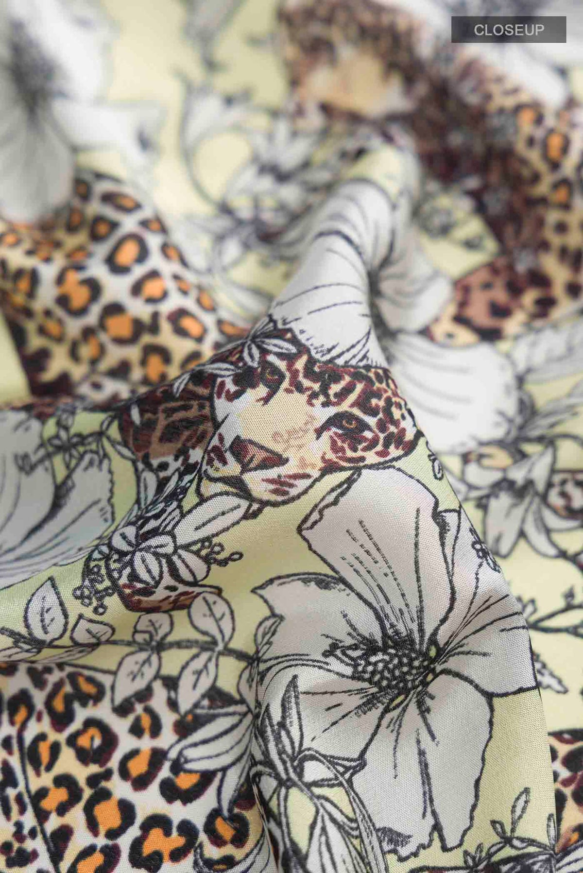Close up of Green Mysore Crepe Saree with Printed design on the body and Zari Border displaying folds