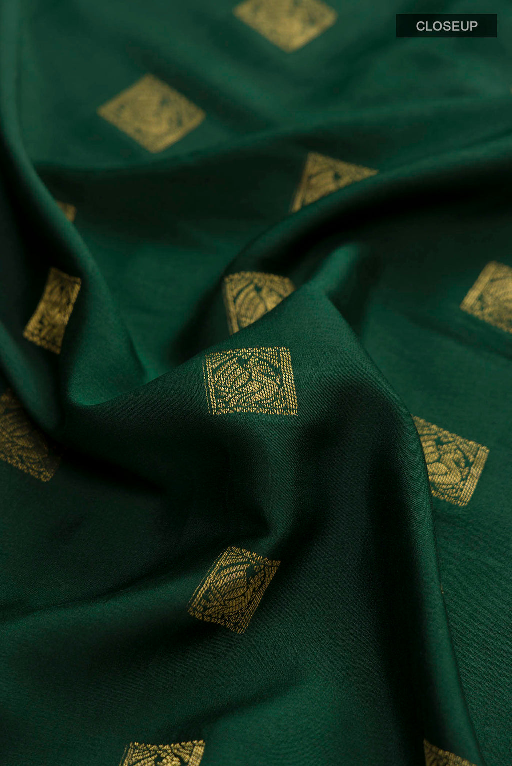 Close up of Green Mysore Crepe Saree with Zari Butta on the body and Zari Border displaying folds