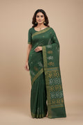 Model wearing a Sage Green Tussar Silk Saree with Zari Butta on the body and Zari Border