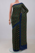Green Printed Silk Saree with Printed design on the body and Plain Border.  displayed on a mannequin