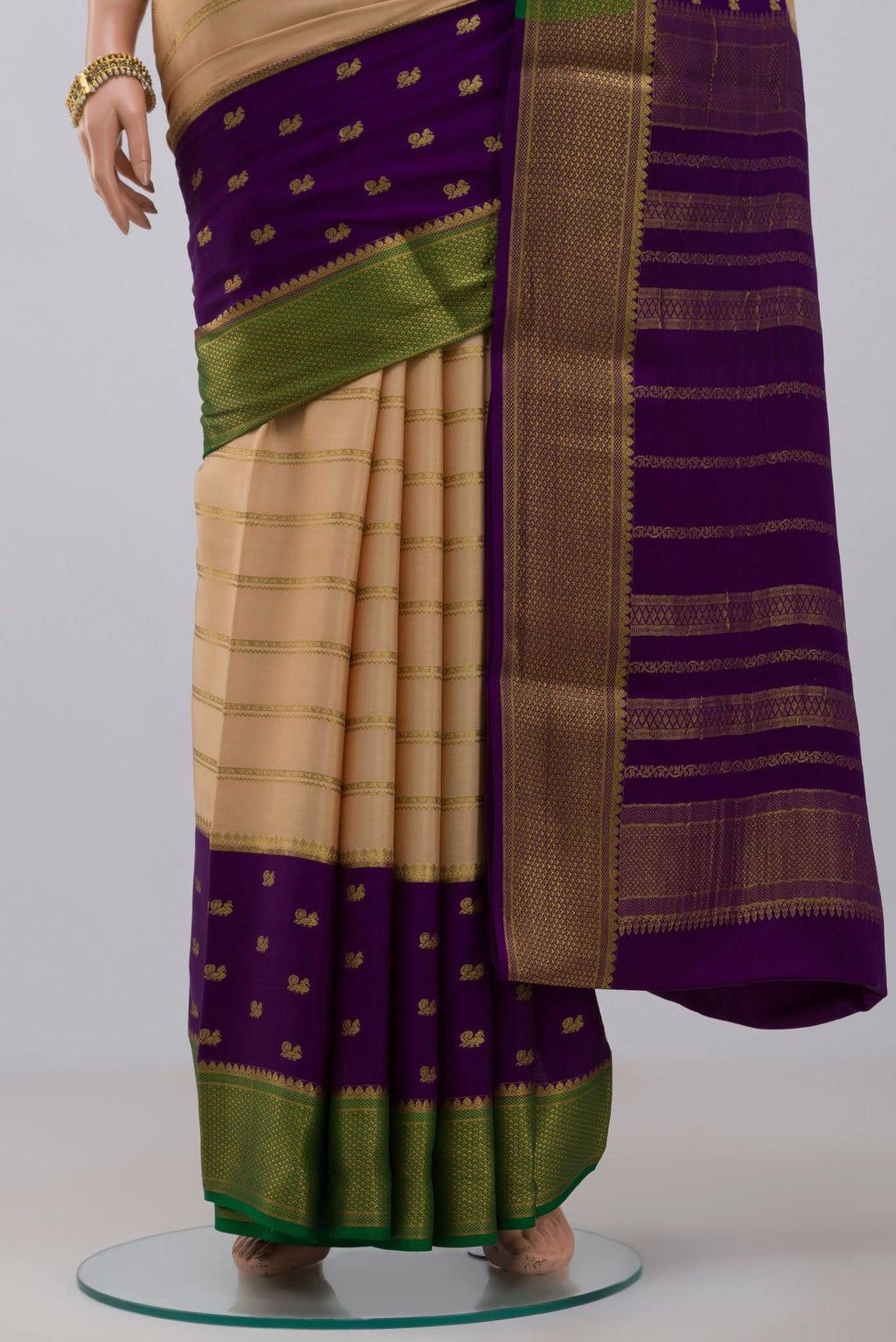 Pleats and pallu of Cream Crepe Saree with Stripes on the body and Zari Border. 