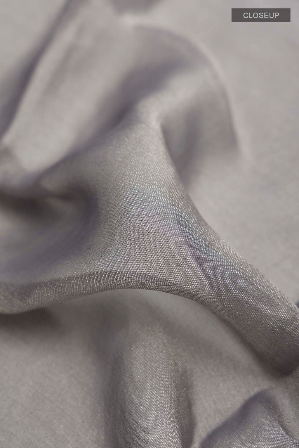 Close up of Grey Banarasi Georgette Saree with Plain Body and Zari Border displaying folds