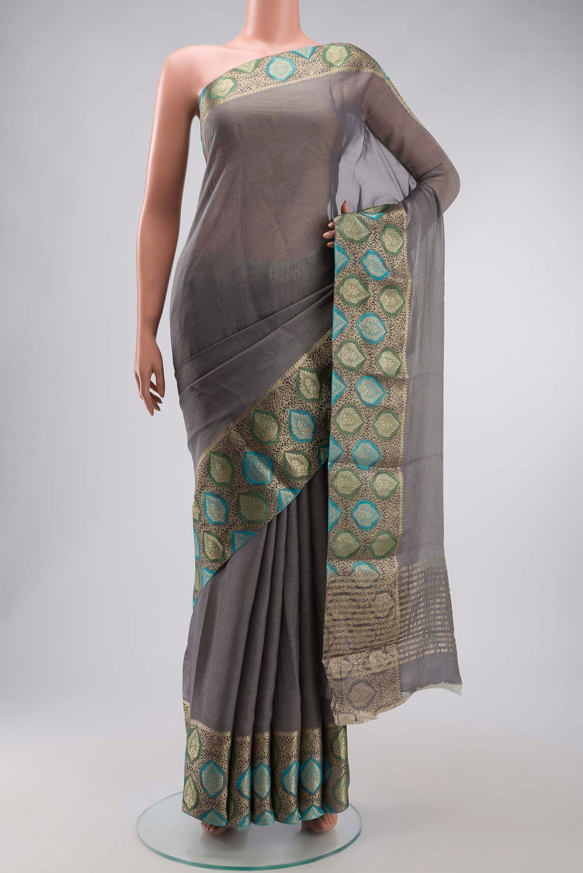 Grey Banarasi Georgette Saree with Plain Body and Zari Border displayed on a mannequin