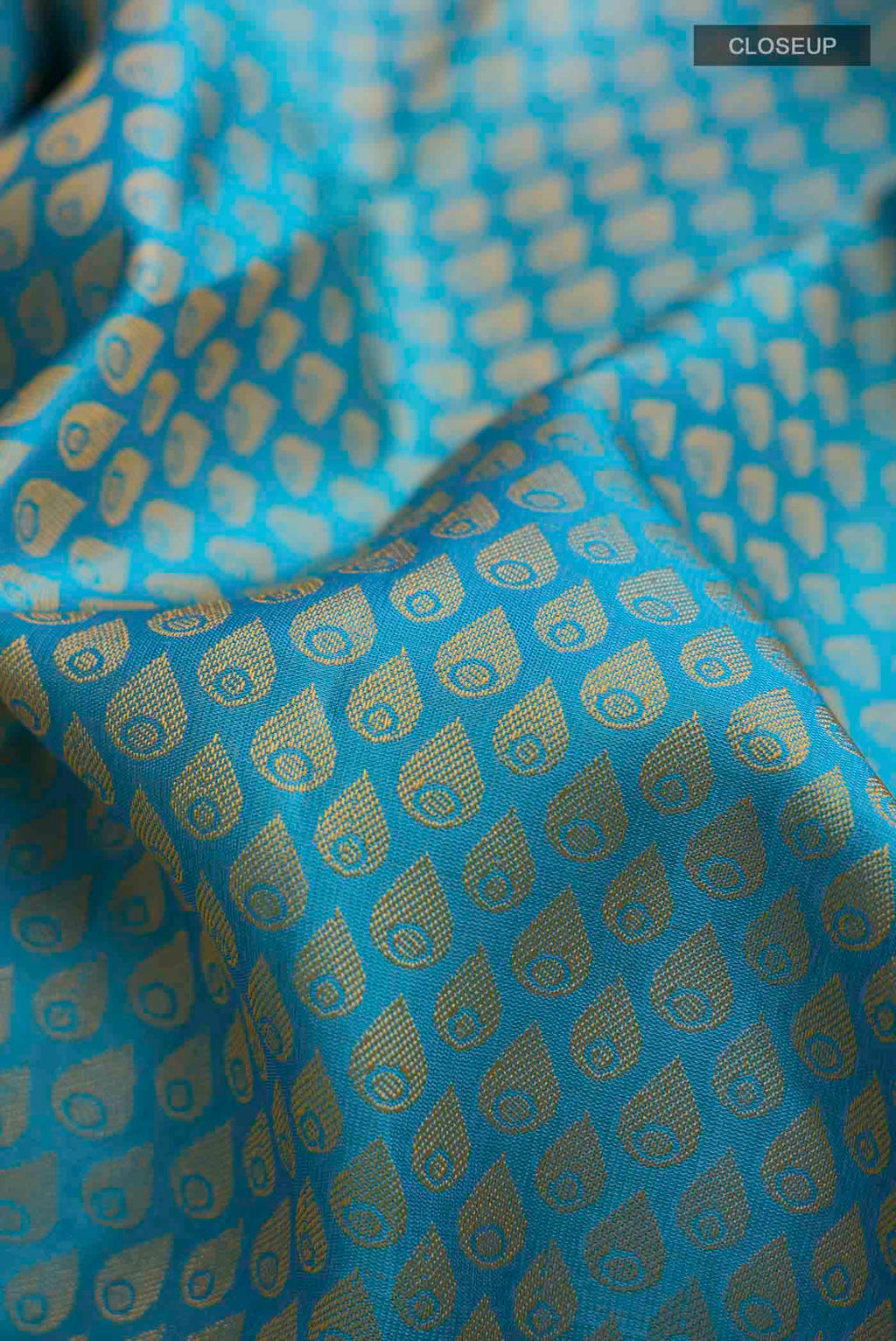 Close up of Blue Kanchipuram Silk Saree with Jacquard design on the body and Zari Border displaying folds