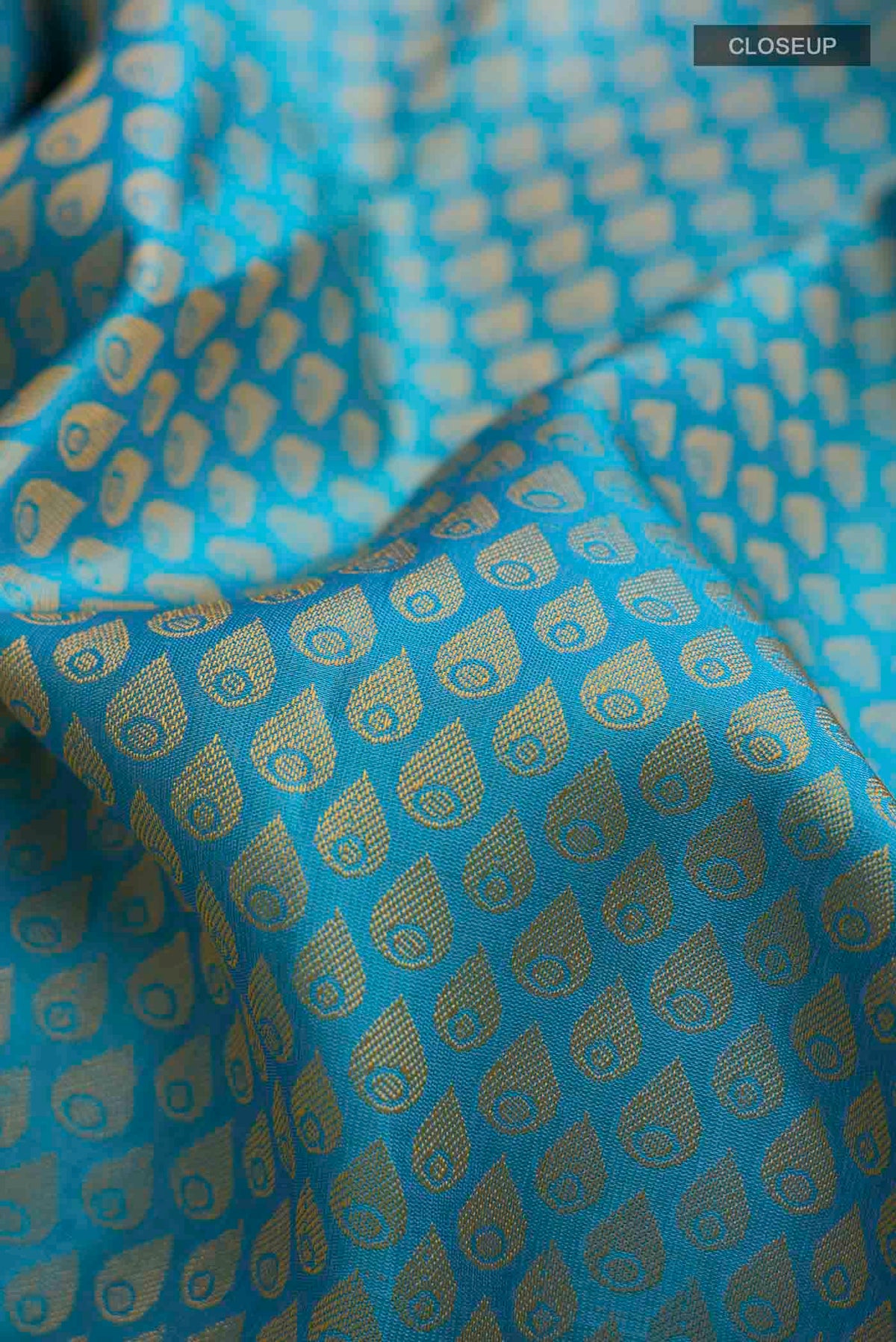Close up of Blue Kanchipuram Silk Saree with Jacquard design on the body and Zari Border displaying folds