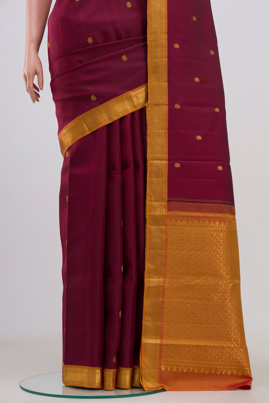 Pleats and pallu of Maroon Kanchipuram Saree with Jacquard With Zari Butta on the body and Zari Border. 