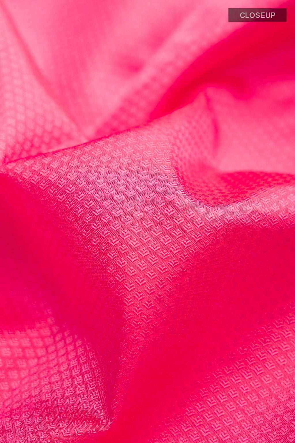 Close up of Pink Kanchipuram Silk Saree with Jacquard design on the body and Zari Border displaying folds