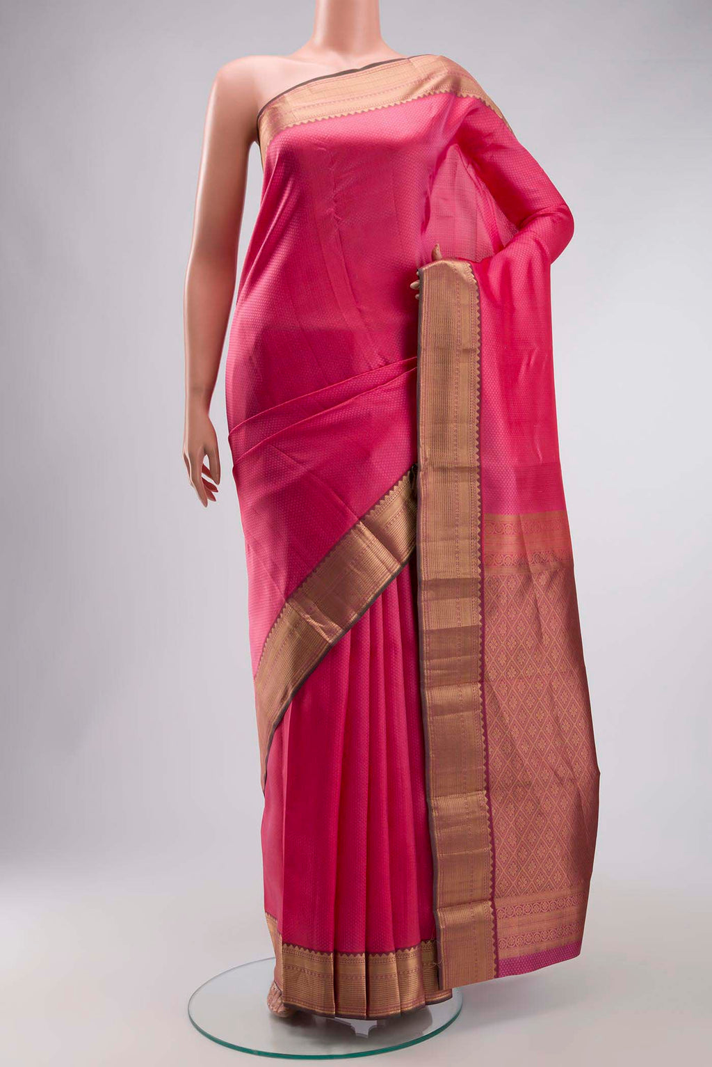 Pink Kanchipuram Silk Saree with Jacquard design on the body and Zari Border displayed on a mannequin