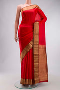 Red Kanchipuram Silk Saree with Jacquard design on the body and Zari Border displayed on a mannequin