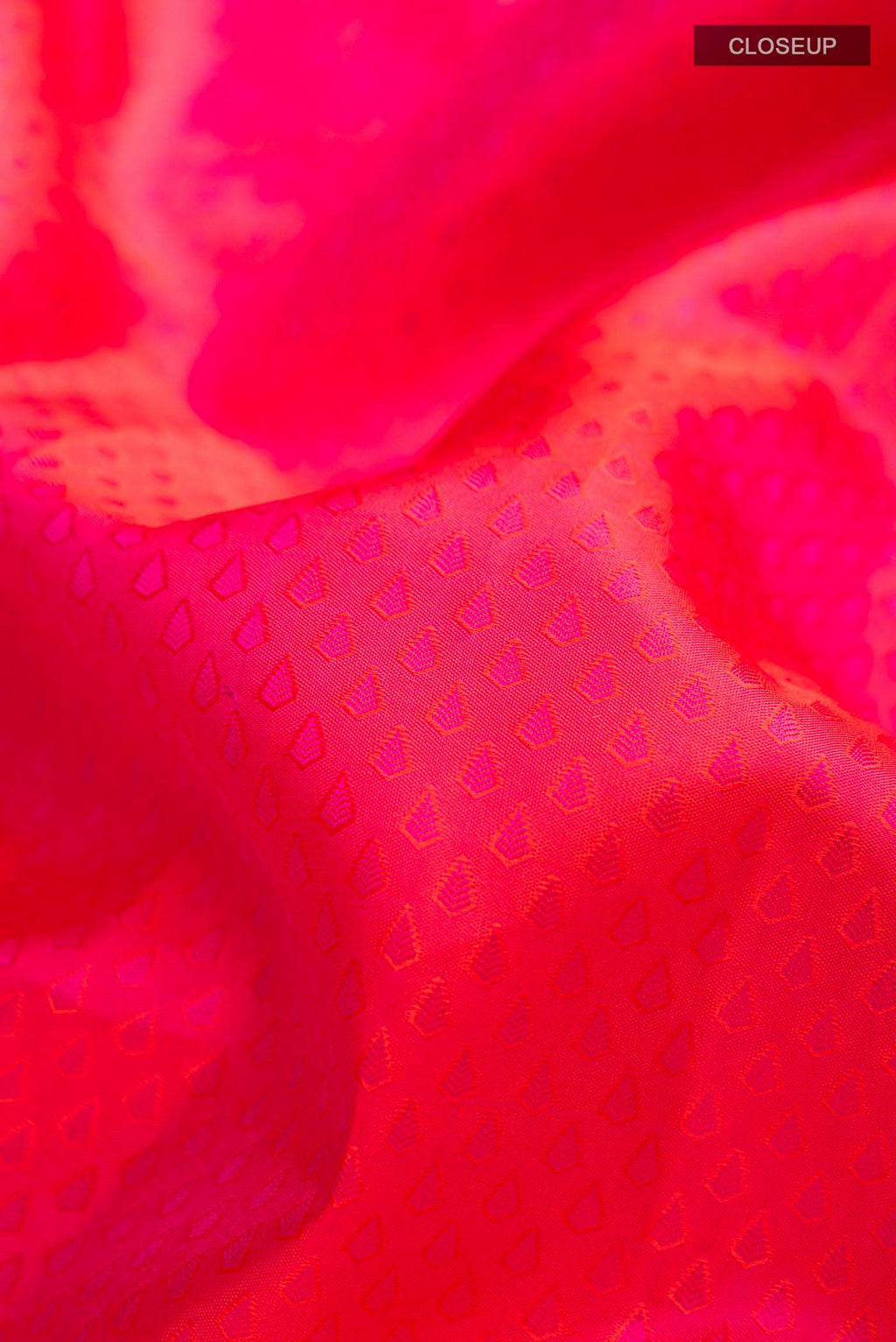 Close up of Pink Kanchipuram Silk Saree with Jacquard design on the body and Zari Border displaying folds
