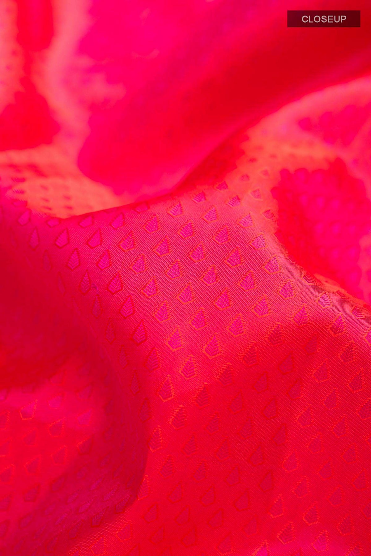 Close up of Pink Kanchipuram Silk Saree with Jacquard design on the body and Zari Border displaying folds