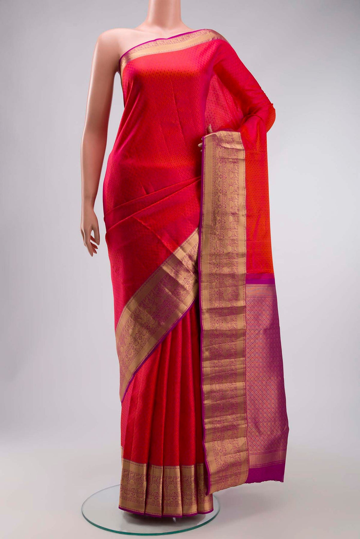 Pink Kanchipuram Silk Saree with Jacquard design on the body and Zari Border displayed on a mannequin