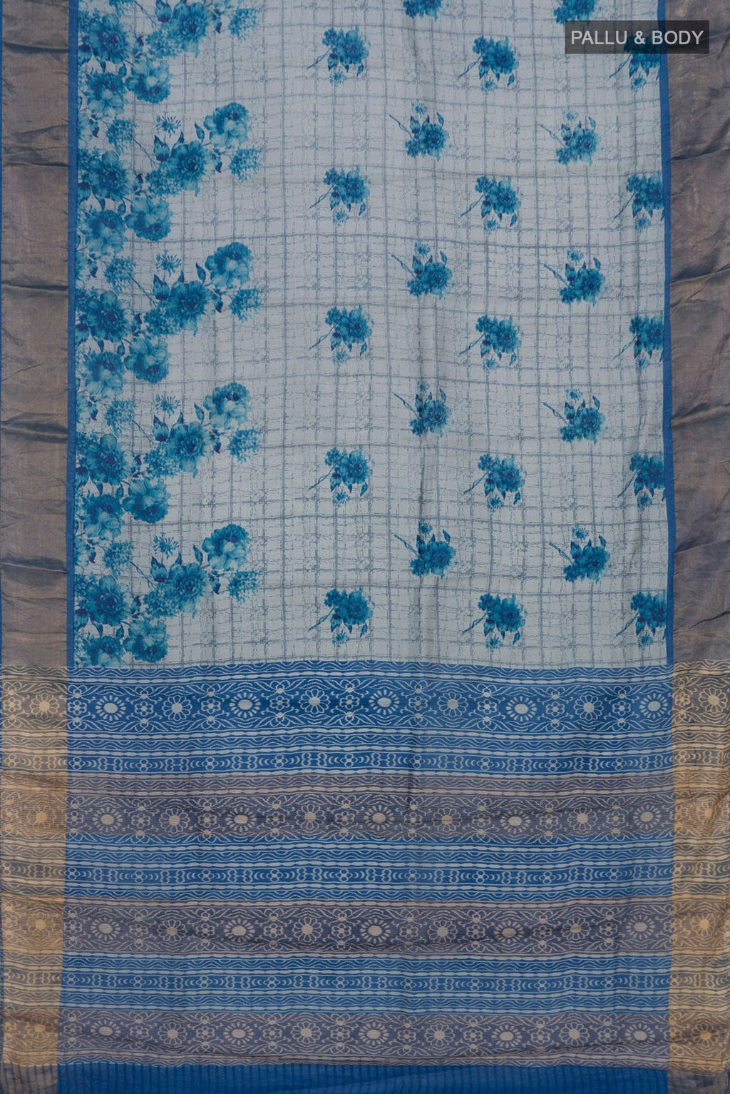 Flat view of Blue Tussar Silk Saree with Printed design on the body and Zari Border. 