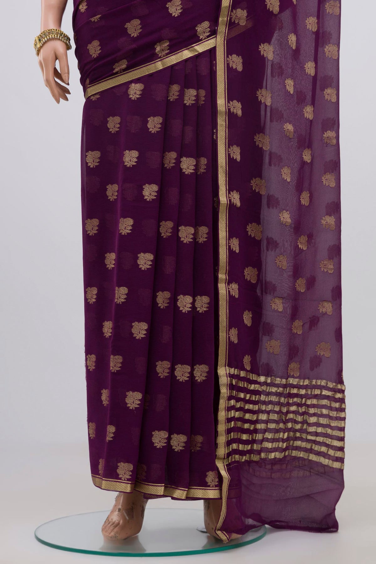 Pleats and pallu of Purple Chiffon Saree with Fancy on the body and Zari Border. 