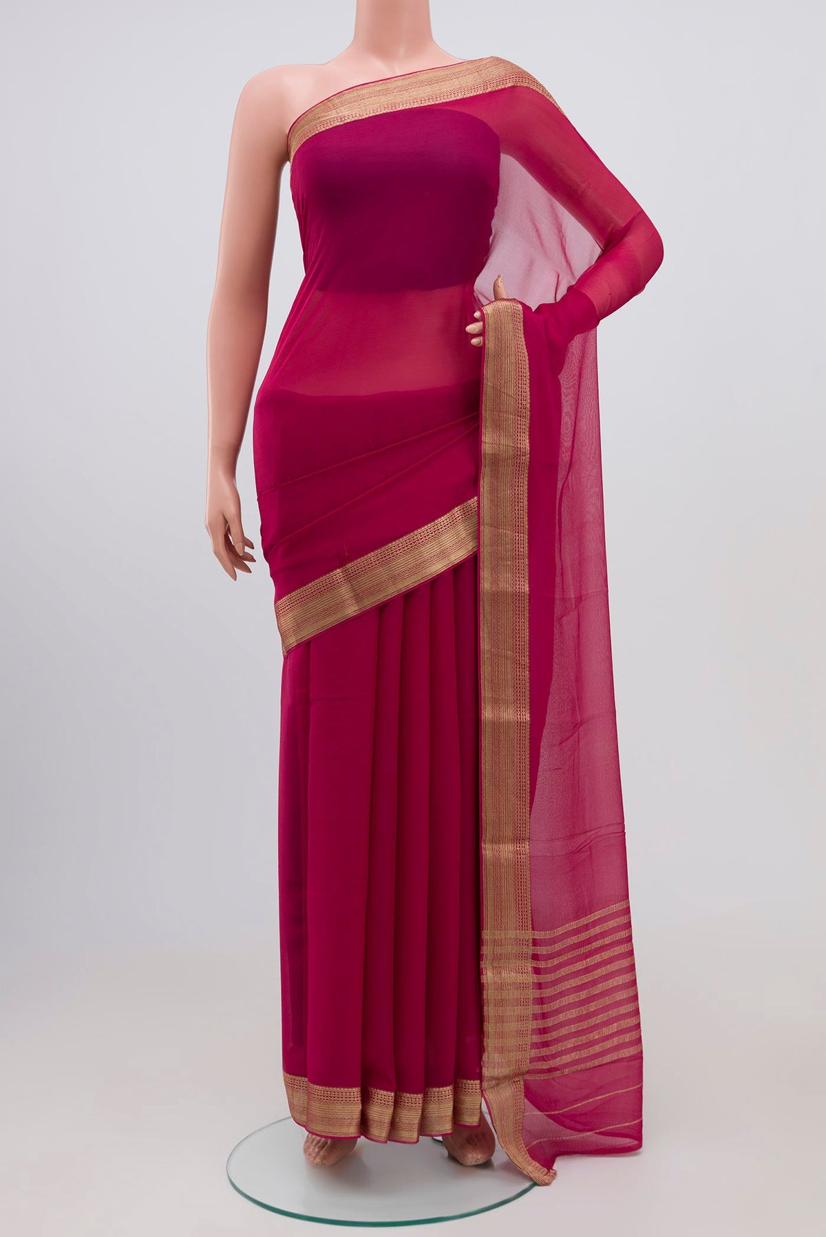 Rani Pink Chiffon Saree with Plain Body and Zari Border.  displayed on a mannequin