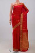 Pure Silk Pure Zari Red Kanchipuram Saree with Zari Butta on the body and Zari Border.  displayed on a mannequin
