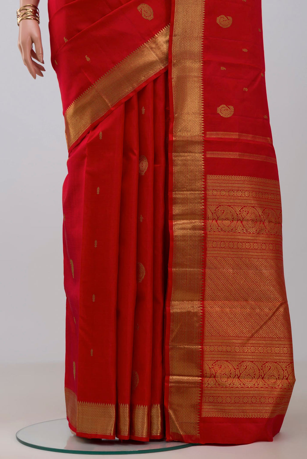 Pleats and pallu of Pure Silk Pure Zari Red Kanchipuram Saree with Zari Butta on the body and Zari Border. 