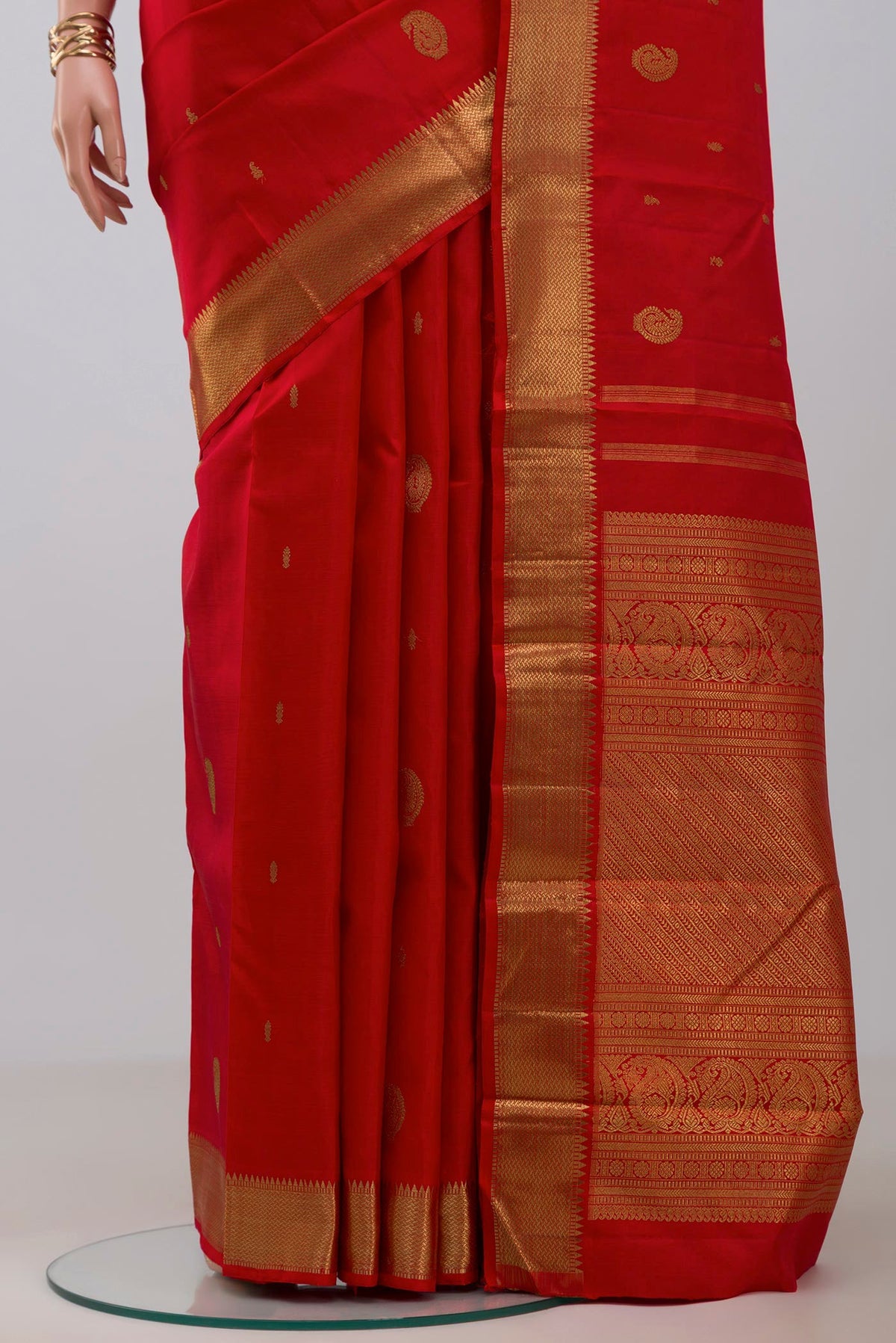Pleats and pallu of Pure Silk Pure Zari Red Kanchipuram Saree with Zari Butta on the body and Zari Border. 