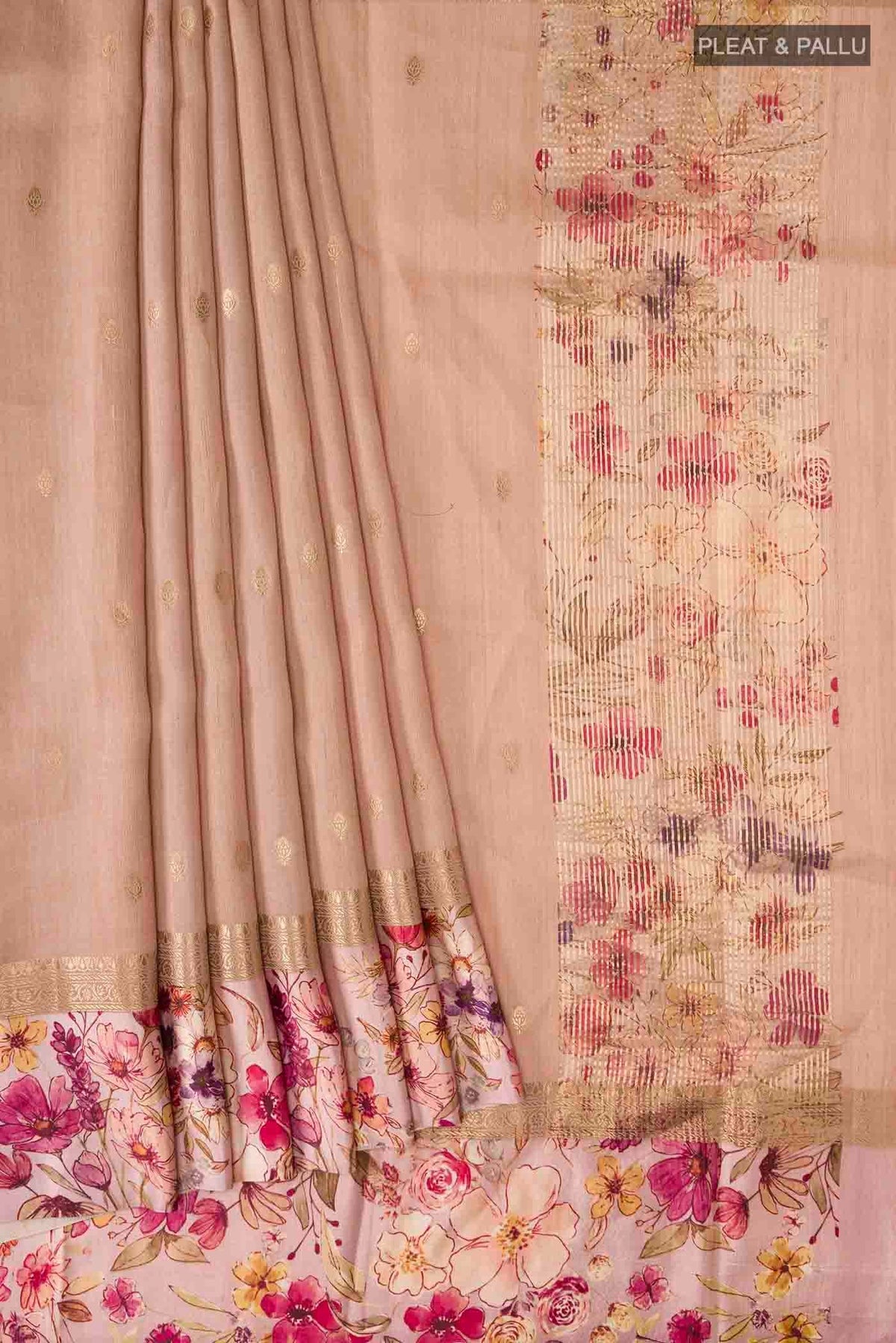 Pleats and pallu of Peach Tussar Silk Saree with Zari Butta on the body and Printed Border