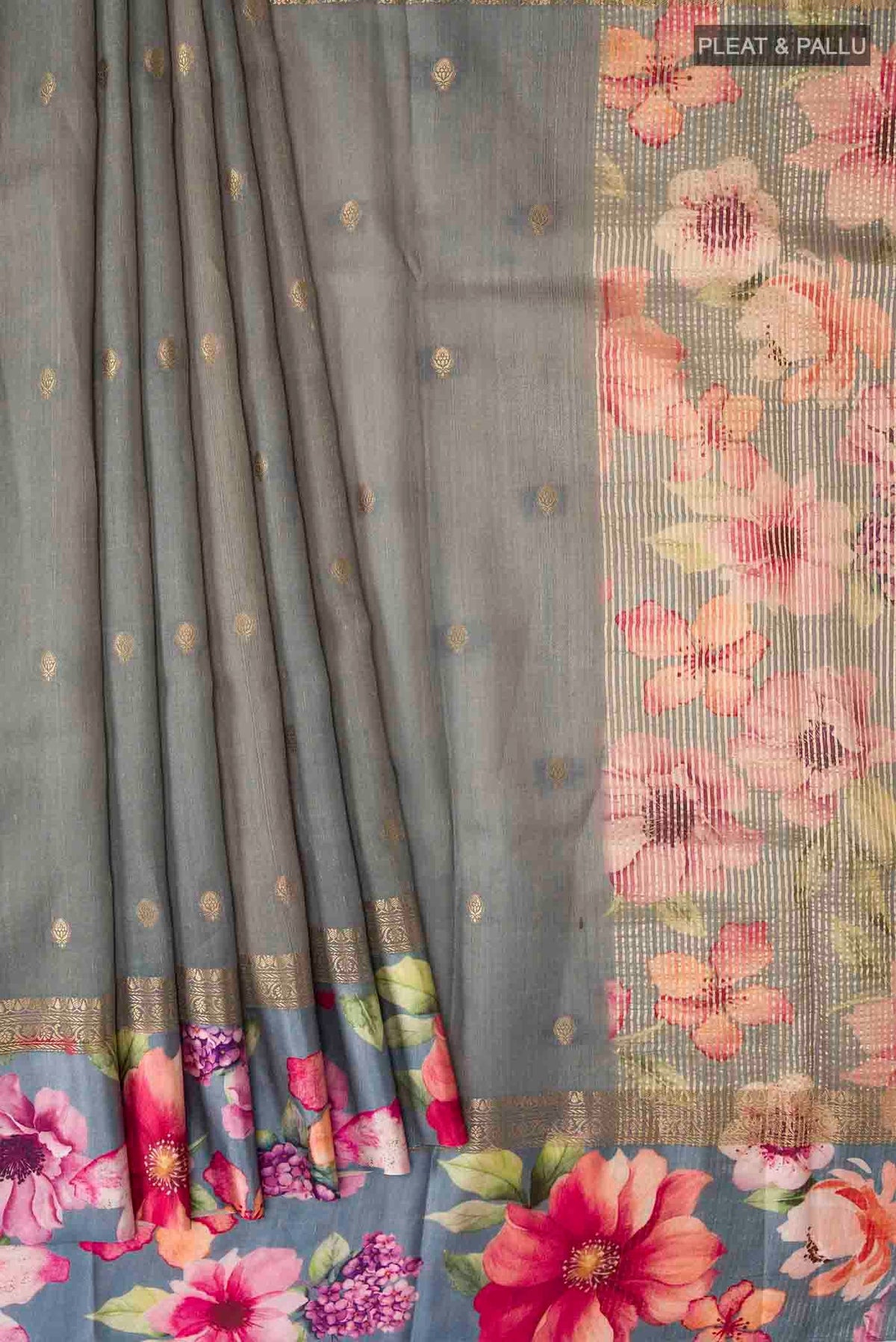 Pleats and pallu of Grey Tussar Silk Saree with Zari Butta on the body and Printed Border