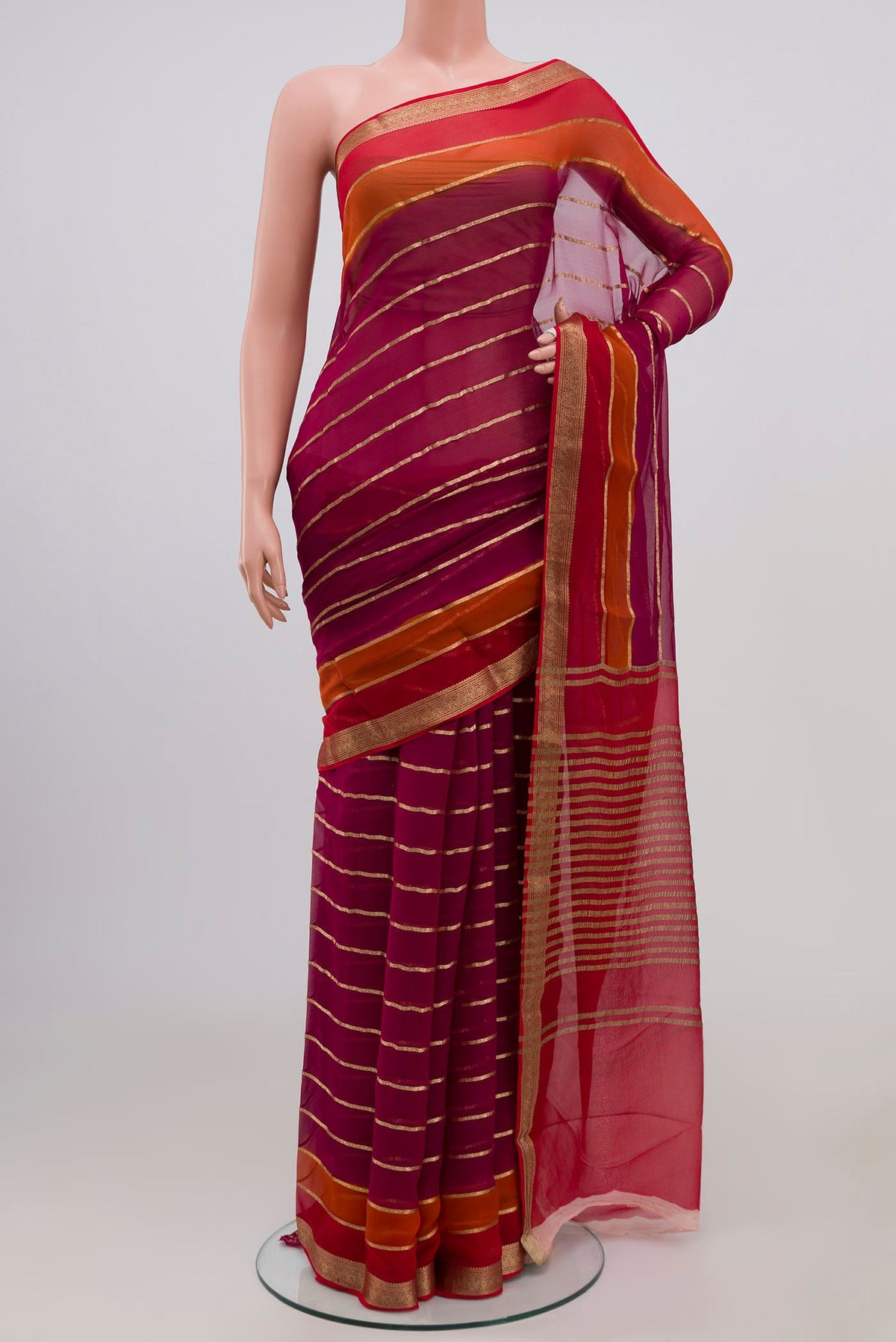 Magenta Chiffon Saree with Veldhari on the body and Zari Border.  displayed on a mannequin
