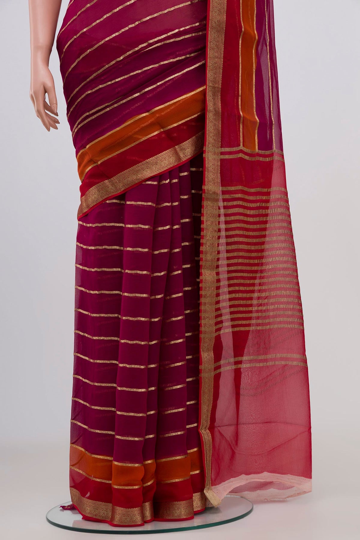Pleats and pallu of Magenta Chiffon Saree with Veldhari on the body and Zari Border. 