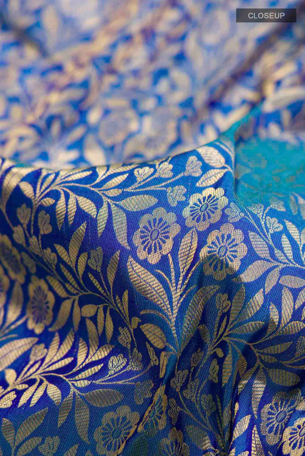 Close up of Blue Kanchipuram Silk Saree with Zari Brocade on the body and Zari Border displaying folds