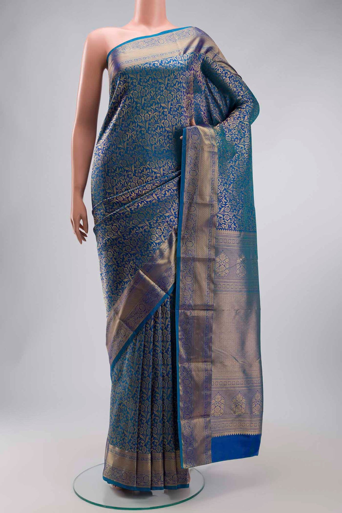 Blue Kanchipuram Silk Saree with Zari Brocade on the body and Zari Border displayed on a mannequin