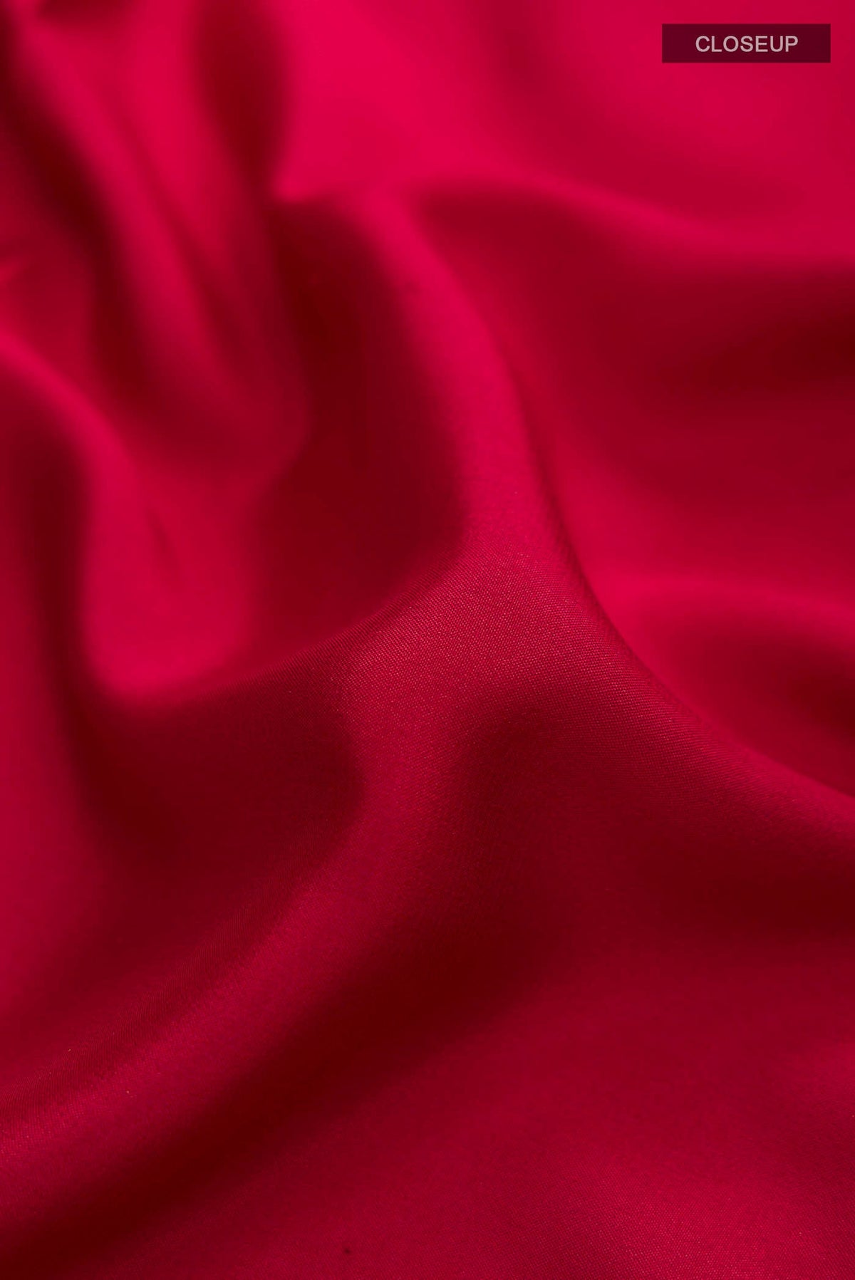 Close up of Maroon Mysore Crepe Saree with Plain Body and Zari Border displaying folds