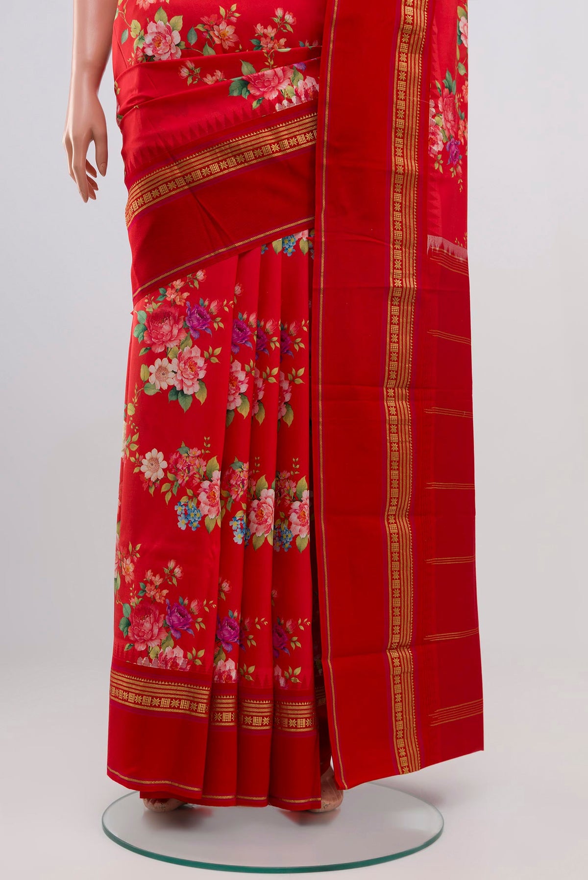 Pleats and pallu of Red Printed Silk Saree with Printed design on the body and Zari Border. 