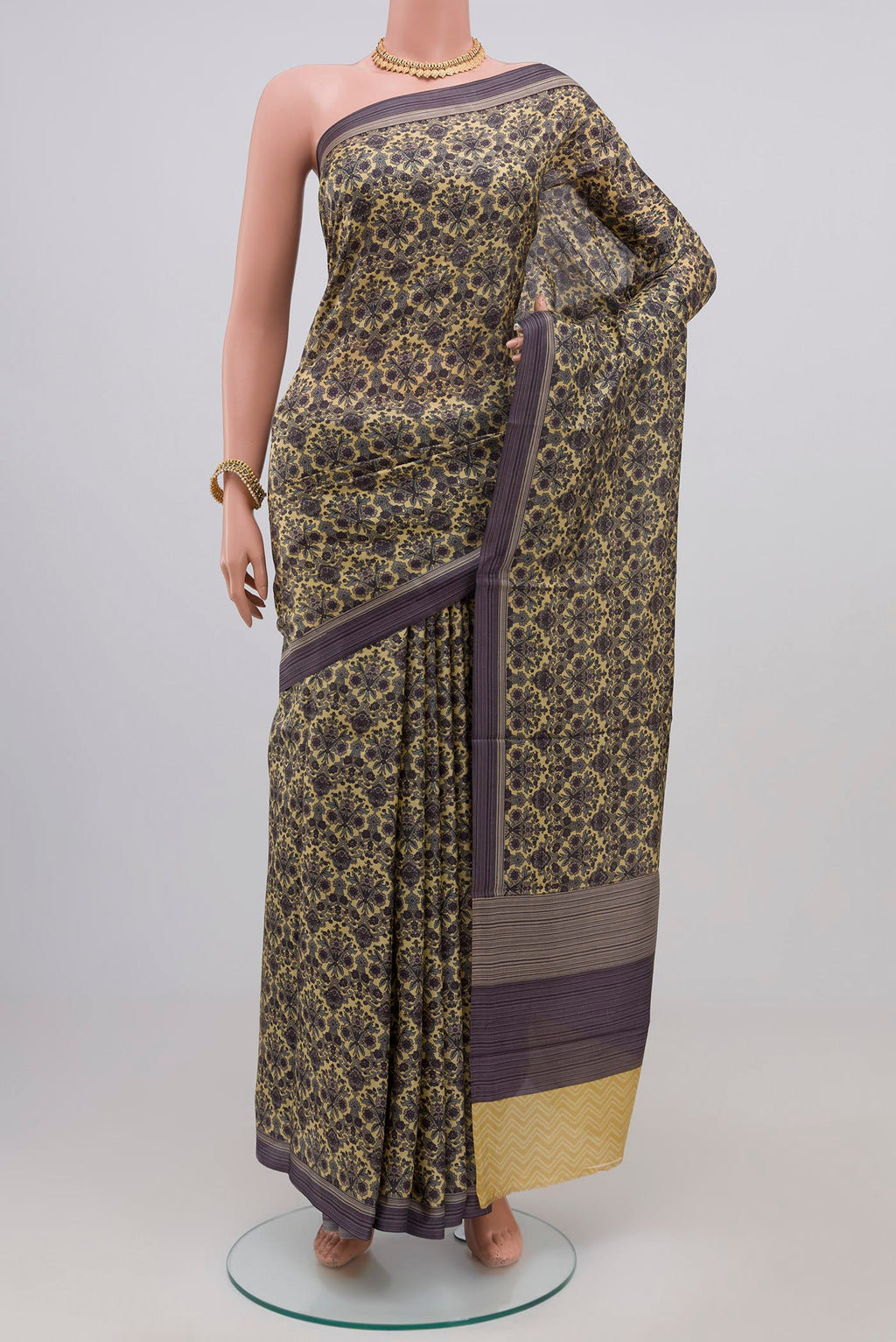 Beige Printed Silk Saree with Printed design on the body and Plain Border.  displayed on a mannequin