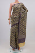 Beige Printed Silk Saree with Printed design on the body and Plain Border.  displayed on a mannequin