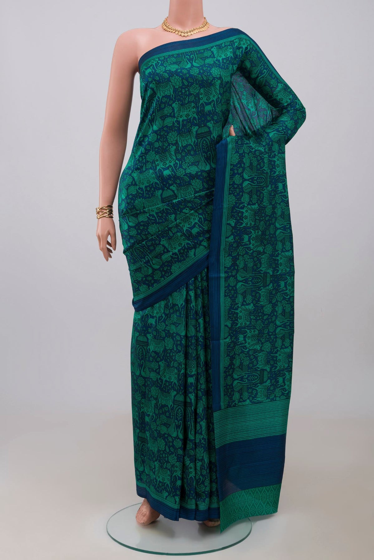 Navy Blue Printed Silk Saree with Printed design on the body and Plain Border.  displayed on a mannequin