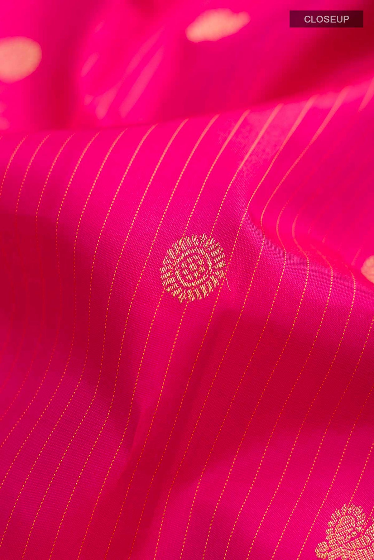 Close up of Pink Kanchipuram Silk Saree with Stripes on the body and Zari Border displaying folds