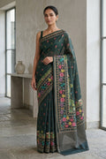 Model wearing a Davys Grey Tussar Silk Saree with Printed design on the body and Printed Border.